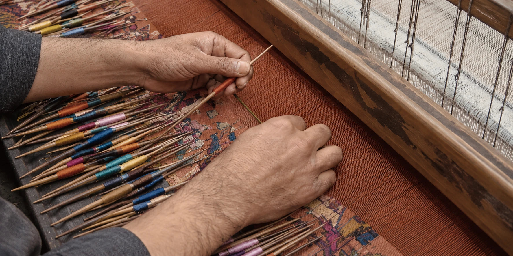 Artisan hands weaving Kashmiri textile